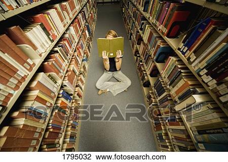 Student in a library View Large Photo Image Stock Image - Student in a library. Fotosearch