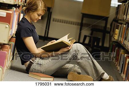 Student reading in a library View Large Photo Image Stock Image - Student reading in a library. Fotosearch
