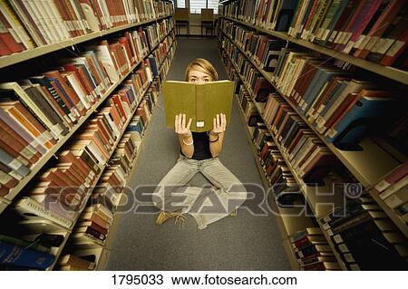 Student reading in a library View Large Photo Image Stock Image - Student reading in a library. Fotosearch