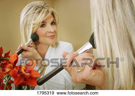 Woman applying makeup View Large Photo Image Stock Photo - Woman applying makeup. Fotosearch