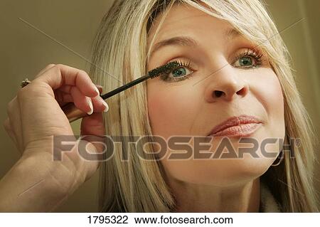 Woman applying mascara View Large Photo Image Stock Image - Woman applying mascara. Fotosearch