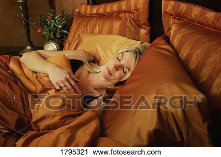 Woman asleep in bed View Large Photo Image Stock Image - Woman asleep in bed. Fotosearch