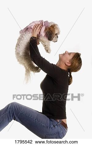 Stock Image - Woman holding dog. Fotosearch