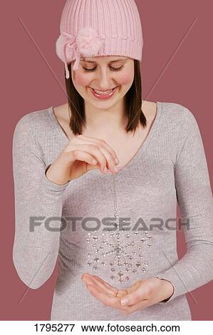 Woman holding snowflake ornament View Large Photo Image Stock Photo - Woman holding snowflake ornament. Fotosearch