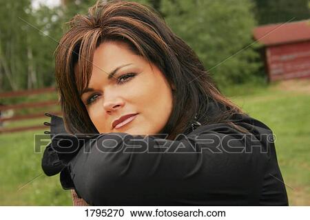 Woman leaning on railing View Large Photo Image Stock Image - Woman leaning on railing. Fotosearch