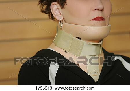Stock Image - Woman wearing a neck brace. Fotosearch
