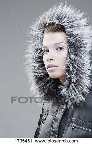 Stock Image - Woman wearing a winter jacket. Fotosearch