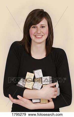 Stock Photo - Woman with her arms full of gifts. Fotosearch