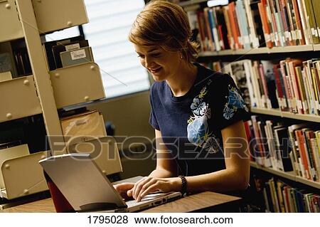 Stock Photo - Woman working on a laptop. Fotosearch