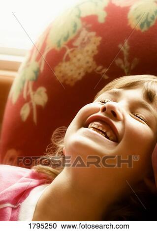 Stock Image - Young girl laughing. Fotosearch