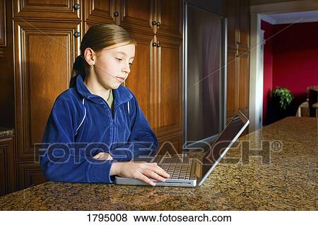 Young girl using laptop View Large Photo Image Stock Photo - Young girl using laptop. Fotosearch