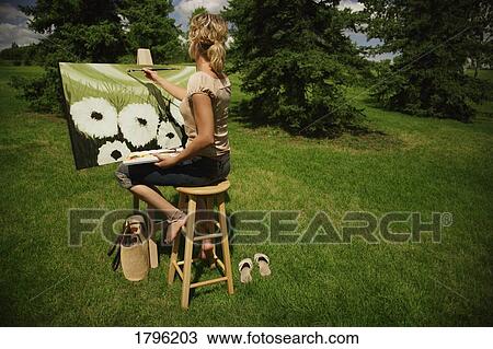 Artist painting on canvas View Large Photo Image Stock Image - Artist painting on canvas. Fotosearch