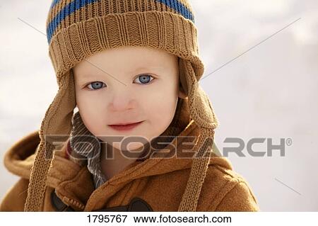Stock Photo - Boy wearing winter clothing. Fotosearch