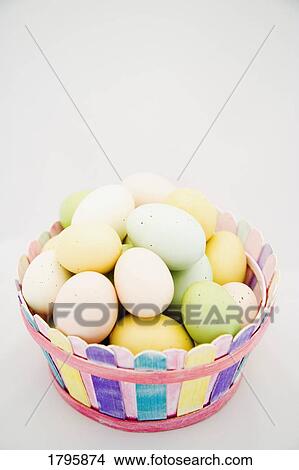 Easter eggs in a basket View Large Photo Image Picture - Easter eggs in a basket. Fotosearch