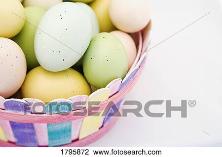 Easter eggs in a basket View Large Photo Image Stock Image - Easter eggs in a basket. Fotosearch