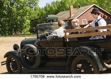 Men in a vintage car View Large Photo Image Stock Photo - Men in a vintage car. Fotosearch