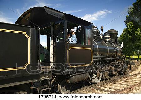 Old-fashioned train and conductor View Large Photo Image Picture - Old-fashioned train and conductor. Fotosearch