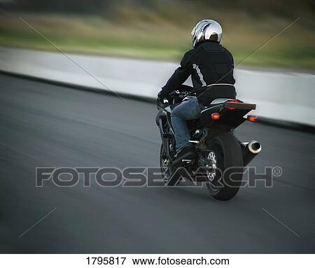 Person riding a motorcycle View Large Photo Image Stock Photo - Person riding a motorcycle. Fotosearch