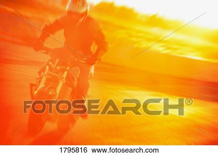 Stock Photograph - Person riding a motorcycle. Fotosearch