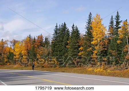 Stock Photo - Person running on a highway. Fotosearch