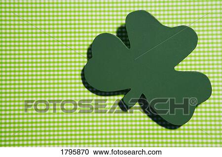 Stock Image - Shamrock on a gingham background. Fotosearch