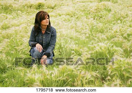 Woman in a field View Large Photo Image Stock Photo - Woman in a field. Fotosearch