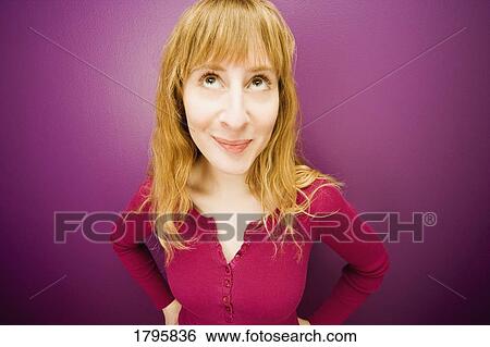 Stock Photograph - Woman in front of a purple background. Fotosearch