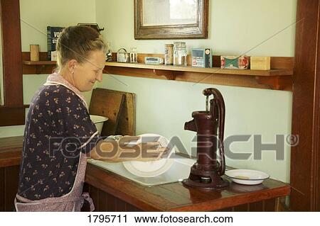 Woman washing dishes View Large Photo Image Stock Image - Woman washing dishes. Fotosearch