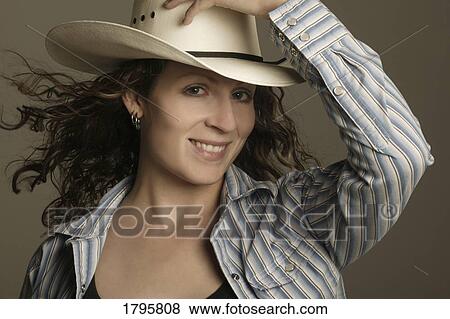 Stock Photo - Woman wearing a cowboy hat. Fotosearch
