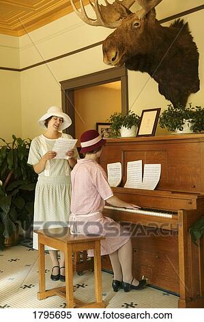 Women playing the piano and singing View Large Photo Image Stock Photography - Women playing the piano and singing. Fotosearch
