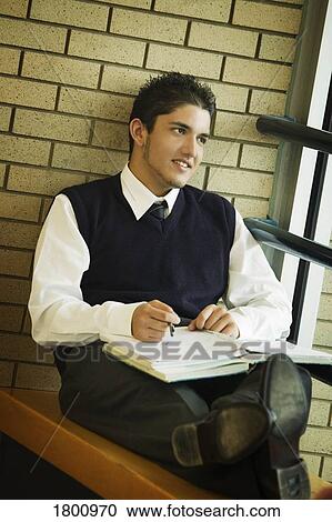 Stock Image - A student in uniform, studying. Fotosearch
