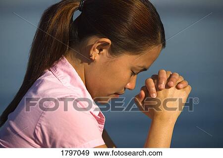 A woman praying View Large Photo Image Stock Photo - A woman praying . Fotosearch