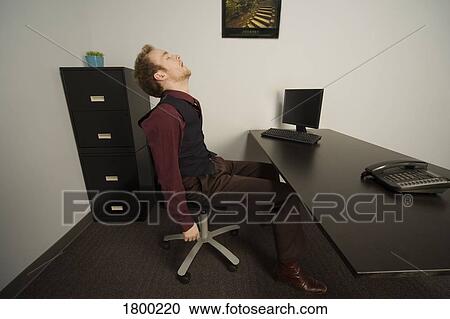 Stock Image - Asleep at work. Fotosearch