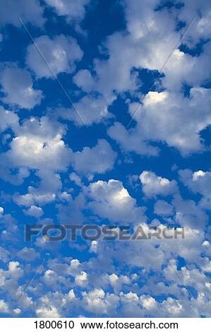 Stock Image - Blue sky with scattered clouds. Fotosearch