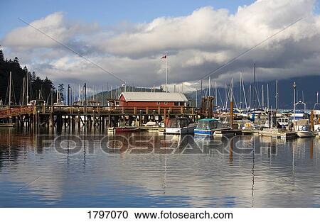 Stock Image - Boats docked at a harbor. Fotosearch