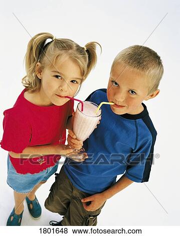 Stock Photo - Boy and girl sharing a milkshake. Fotosearch