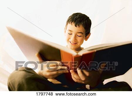 Stock Photo - Boy reading a book. Fotosearch