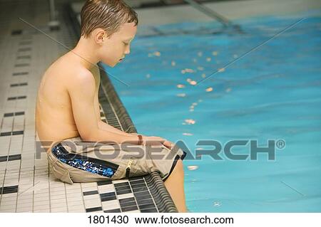 Boy sitting on the edge of the pool View Large Photo Image Stock Image - Boy sitting on the edge of the pool. Fotosearch