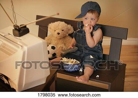 Boy watching television View Large Photo Image Stock Photography - Boy watching television. Fotosearch