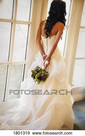 Stock Photo - Bride looking out the window. Fotosearch