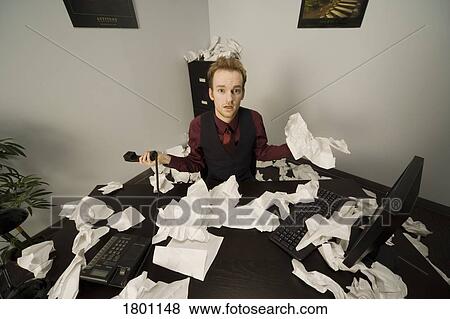 Stock Photo - Businessman at messy desk. Fotosearch