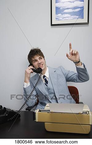 Businessman on phone in office View Large Photo Image Stock Photograph - Businessman on phone in office. Fotosearch