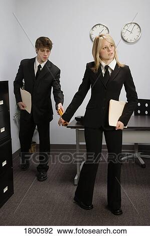 Businessman passing baton to businesswoman View Large Photo Image Stock Image - Businessman passing baton to businesswoman. Fotosearch