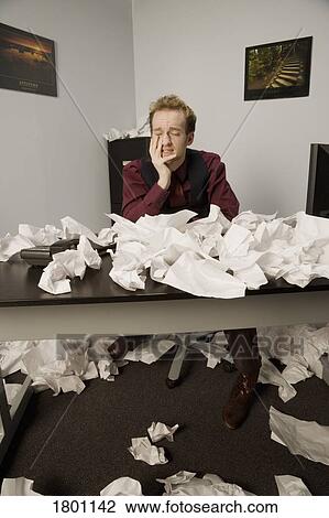 Businessman with crumpled papers in office View Large Photo Image Stock Image - Businessman with crumpled papers in office. Fotosearch