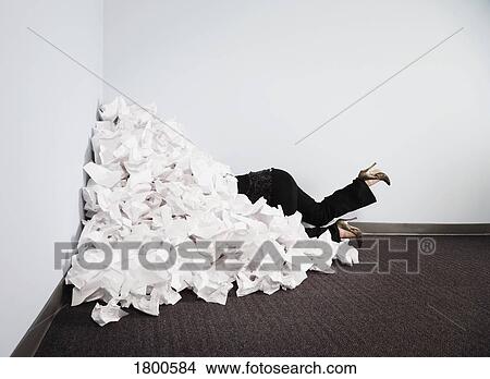 Picture - Businesswoman buried in pile of paper. Fotosearch
