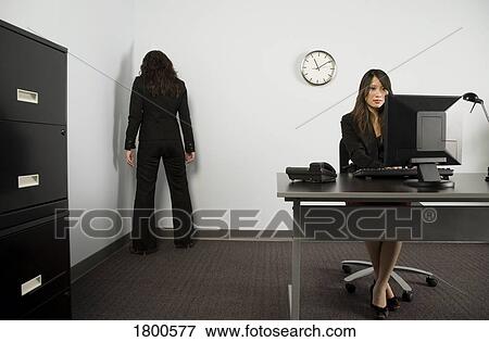 Businesswoman facing corner in office View Large Photo Image Stock Photo - Businesswoman facing corner in office. Fotosearch