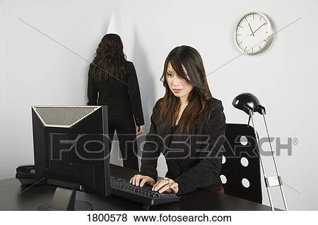 Stock Photo - Businesswoman facing corner in office. Fotosearch