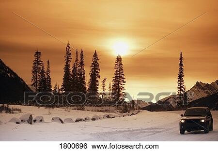 Stock Photograph - Car driving on snowy road. Fotosearch