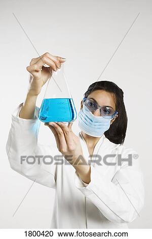 Stock Image - Chemist holding flask. Fotosearch