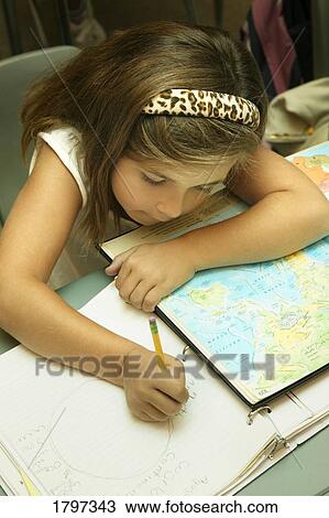 Stock Image - Child working on school work. Fotosearch